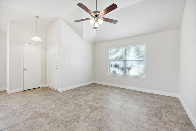 tiled empty room featuring vaulted ceiling and ceiling fan