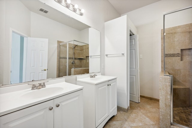 bathroom with vanity, tile patterned floors, and a shower with shower door