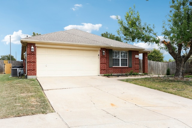 ranch-style home with cooling unit, a garage, and a front lawn