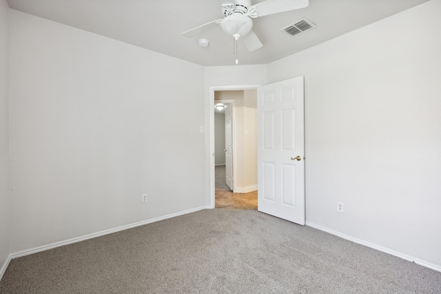 carpeted spare room with ceiling fan