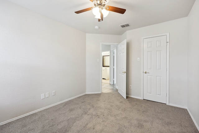 unfurnished bedroom with ceiling fan and light colored carpet