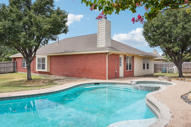 view of swimming pool featuring an in ground hot tub