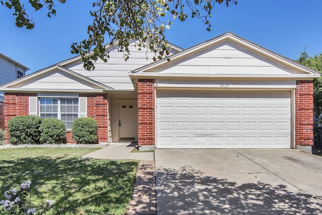 ranch-style home with a front lawn and a garage