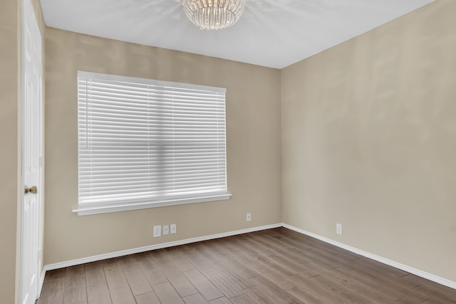 4629 Grant Park Ave, Fort Worth, TX 76137 - spare room with baseboards, an inviting chandelier, and wood finished floors