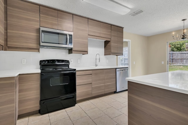 4629 Grant Park Ave, Fort Worth, TX 76137 - kitchen with light tile patterned floors, appliances with stainless steel finishes, light countertops, a sink, and backsplash