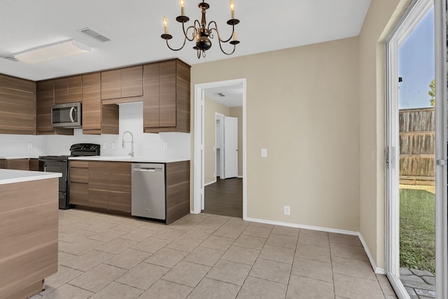 4629 Grant Park Ave, Fort Worth, TX 76137 - kitchen featuring a chandelier, light tile patterned floors, light countertops, visible vents, and appliances with stainless steel finishes