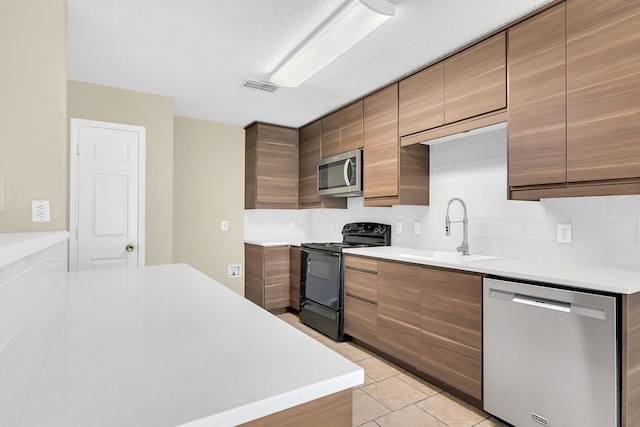 4629 Grant Park Ave, Fort Worth, TX 76137 - kitchen featuring light tile patterned floors, light countertops, visible vents, appliances with stainless steel finishes, and a sink
