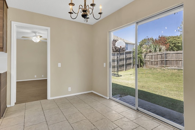 interior space with ceiling fan with notable chandelier and light tile patterned floors