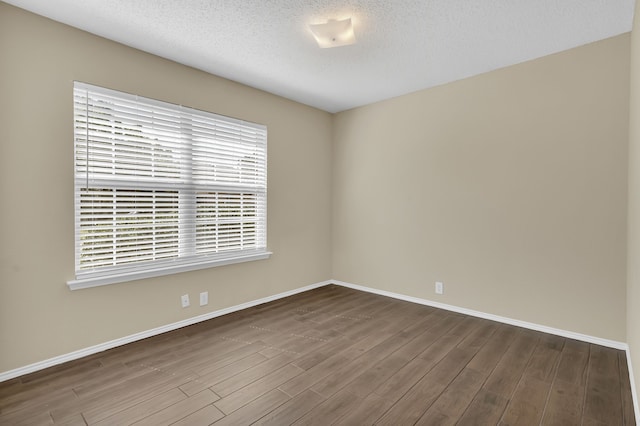 4629 Grant Park Ave, Fort Worth, TX 76137 - spare room featuring baseboards, wood finished floors, and a textured ceiling