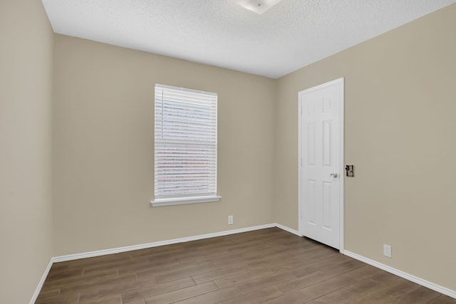 4629 Grant Park Ave, Fort Worth, TX 76137 - empty room featuring a healthy amount of sunlight, baseboards, and wood finished floors