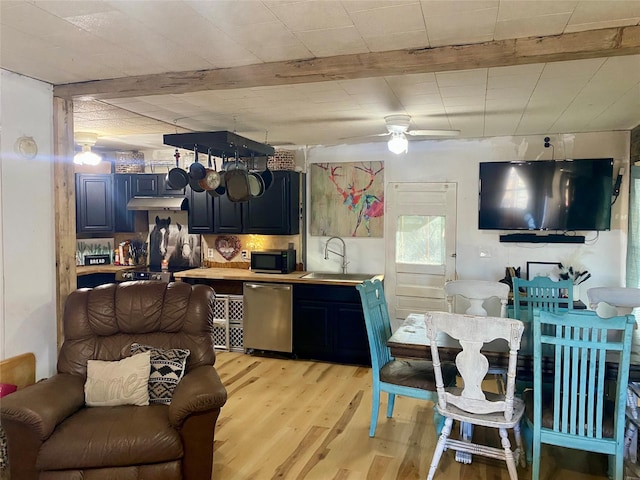 kitchen with blue cabinets, dishwasher, sink, ceiling fan, and light hardwood / wood-style floors