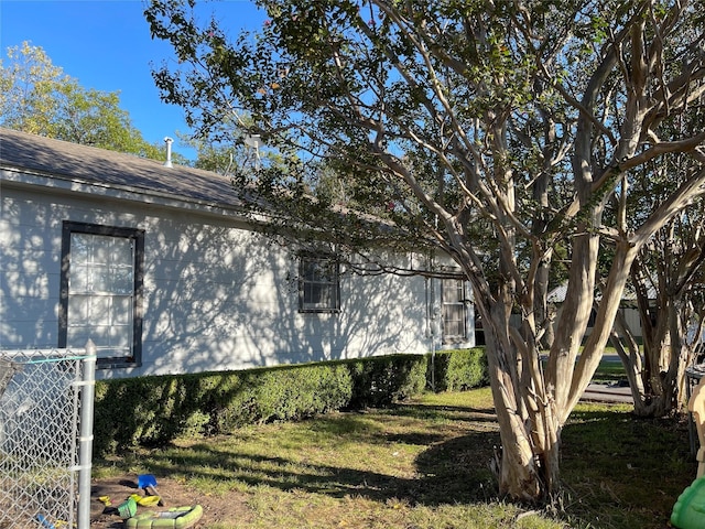 view of side of home featuring a yard