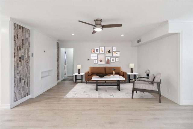 sitting room with ceiling fan, crown molding, and light hardwood / wood-style flooring