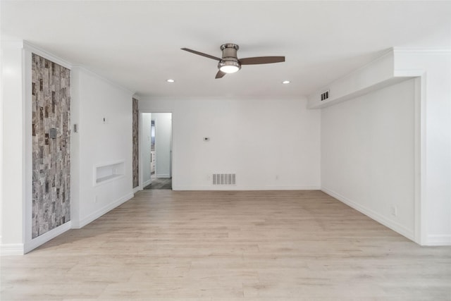 empty room featuring ceiling fan, light hardwood / wood-style floors, and ornamental molding