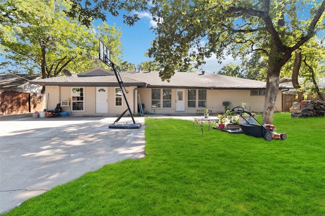 back of property featuring a lawn and a patio area