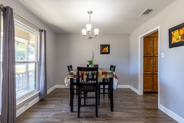 dining space with a chandelier and dark wood-type flooring