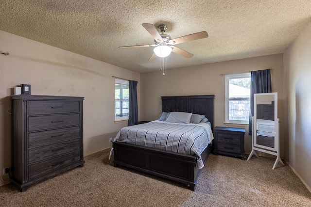 bedroom with carpet, ceiling fan, and a textured ceiling