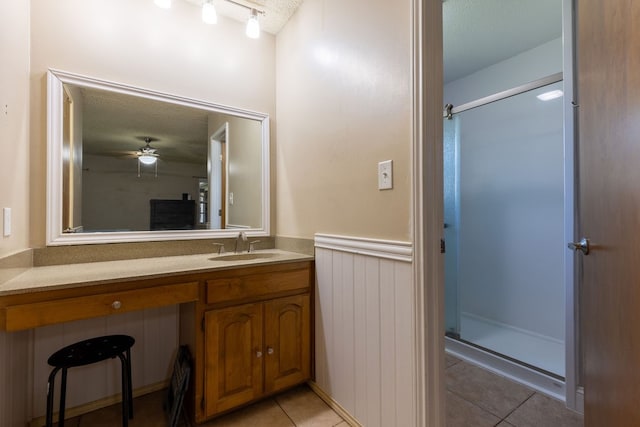 bathroom featuring ceiling fan, vanity, tile patterned flooring, and an enclosed shower