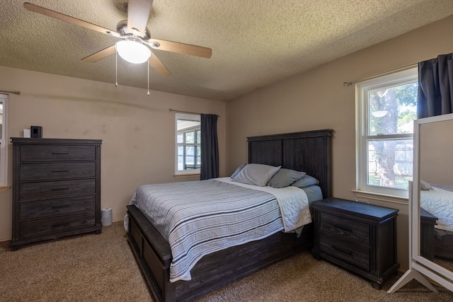 bedroom featuring a textured ceiling, ceiling fan, and light colored carpet