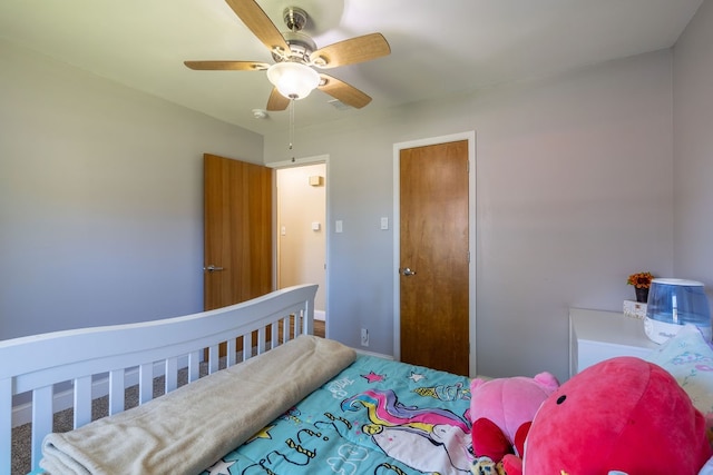 bedroom featuring ceiling fan and carpet