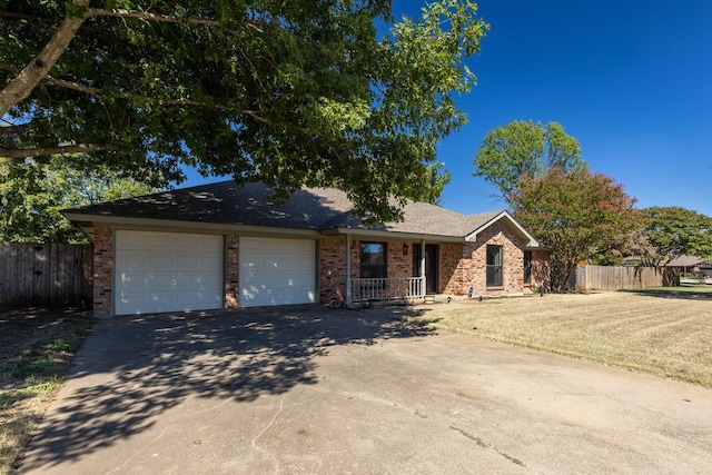 ranch-style home featuring a garage and a front lawn