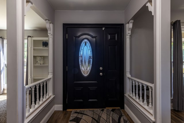 foyer entrance with dark wood-type flooring