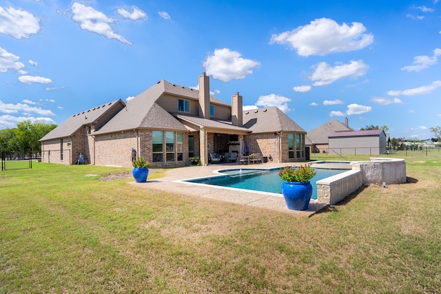 rear view of house featuring a yard and a patio