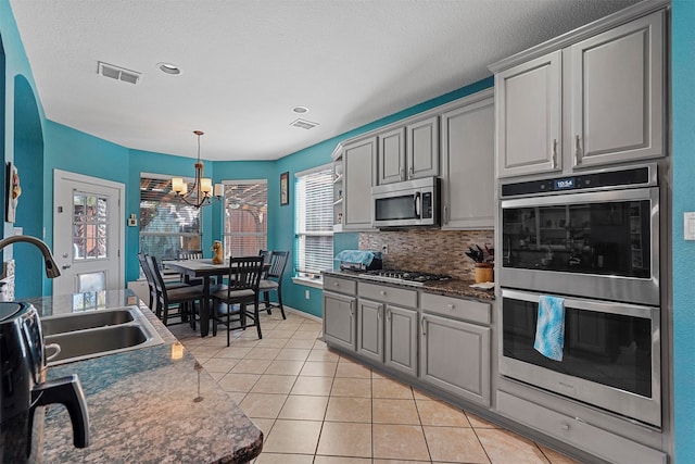 kitchen featuring gray cabinets, appliances with stainless steel finishes, and sink