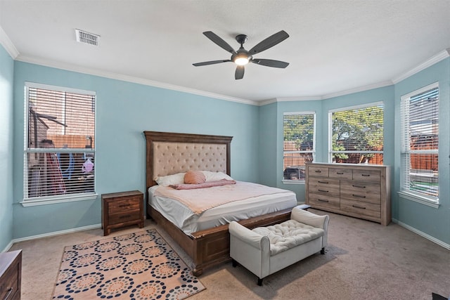 carpeted bedroom with ceiling fan and crown molding