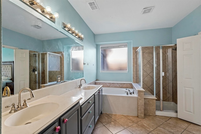 bathroom featuring vanity, independent shower and bath, and tile patterned floors