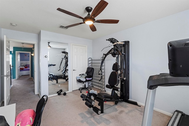 workout area with light carpet and ceiling fan