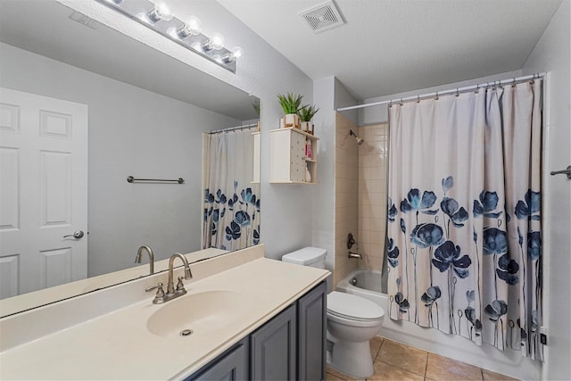 full bathroom with vanity, a textured ceiling, tile patterned flooring, toilet, and shower / bathtub combination with curtain