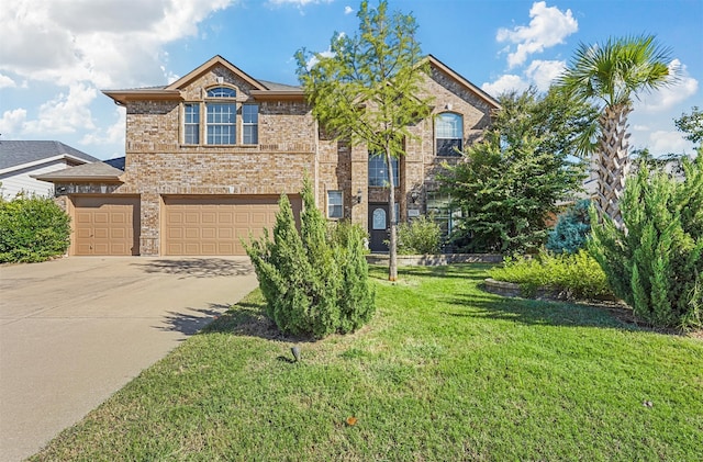 view of property featuring a garage and a front lawn