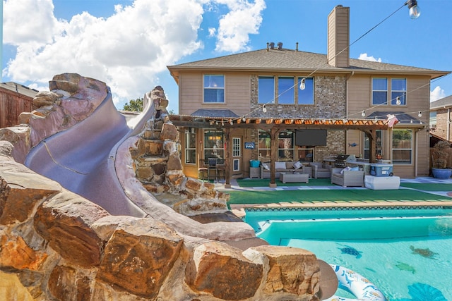 view of swimming pool with an outdoor living space, grilling area, a pergola, and a patio