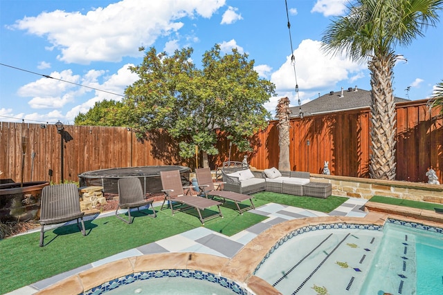 view of swimming pool with a patio area, a hot tub, and an outdoor living space