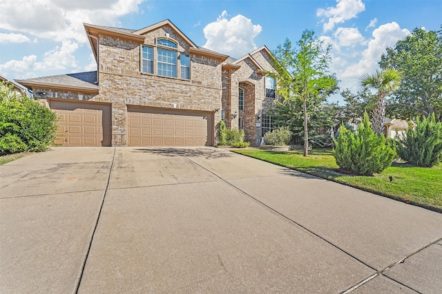 view of front facade featuring a garage and a front yard