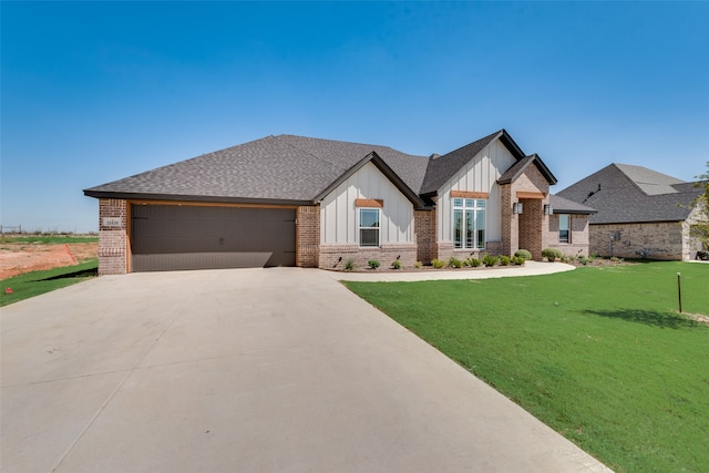 view of front of home with a garage and a front lawn