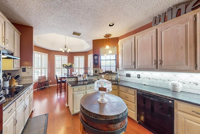 kitchen with wood-type flooring, decorative light fixtures, backsplash, black appliances, and an inviting chandelier