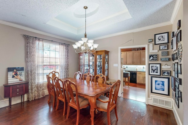 dining space featuring a raised ceiling, crown molding, dark hardwood / wood-style flooring, and a chandelier