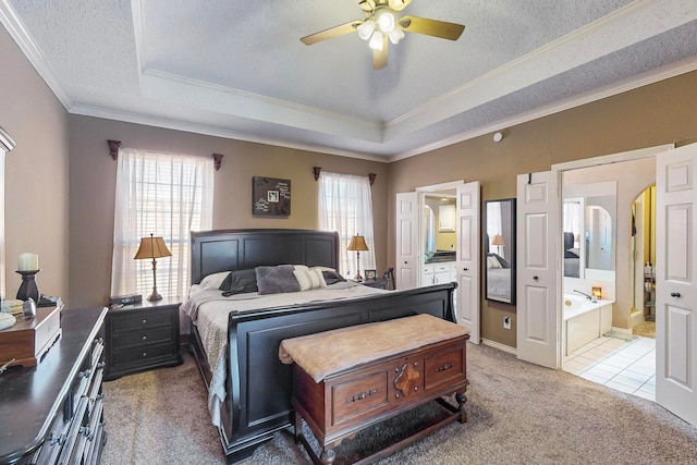 bedroom featuring carpet floors, a textured ceiling, ensuite bath, and ceiling fan