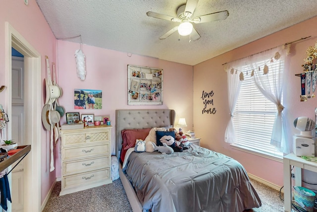 carpeted bedroom with ceiling fan and a textured ceiling