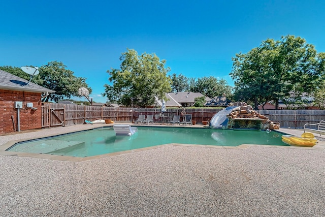 view of pool featuring a patio and a water slide