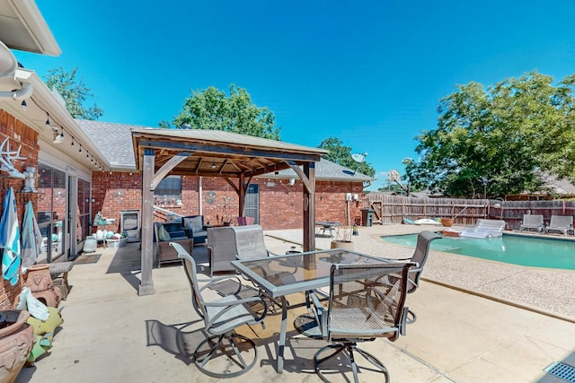 view of patio / terrace featuring a gazebo and a fenced in pool