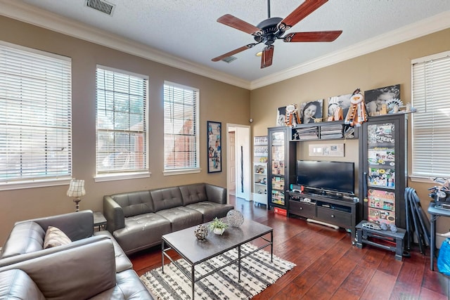 living room with ornamental molding, ceiling fan, dark hardwood / wood-style floors, and a textured ceiling