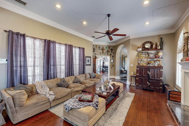 living room featuring ornamental molding, ceiling fan, and dark wood-type flooring