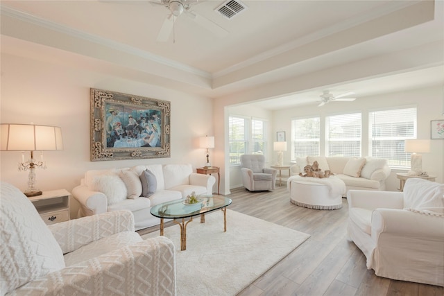 living room with light hardwood / wood-style floors, ceiling fan, and ornamental molding