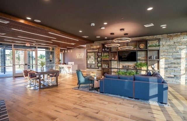 living room featuring french doors and light hardwood / wood-style floors