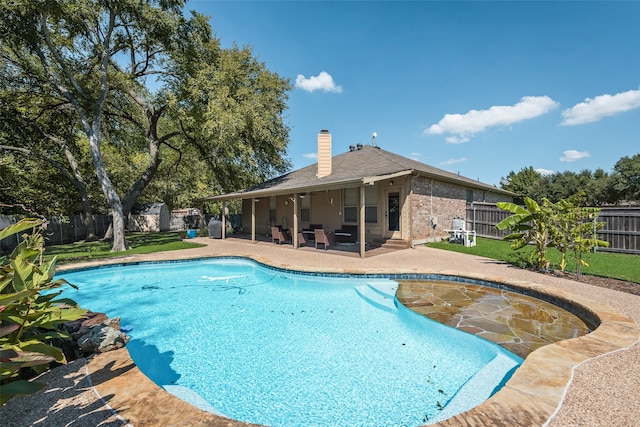 view of pool featuring a yard and a patio area