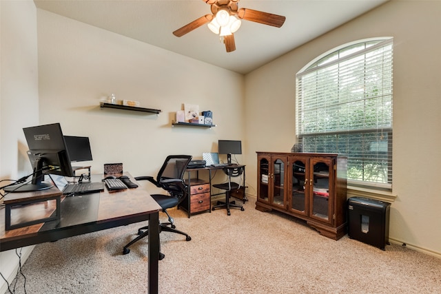 home office featuring light carpet, ceiling fan, and plenty of natural light