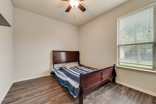 bedroom with multiple windows, dark wood-type flooring, and ceiling fan